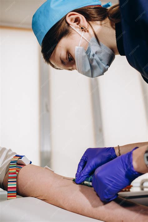 Close Up Of Nurse Disinfecting Male Arm Before Blood Test Man Is