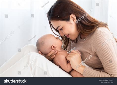 Mom Touching Newborn Baby Face With Love And Care Form Top Angle Stock